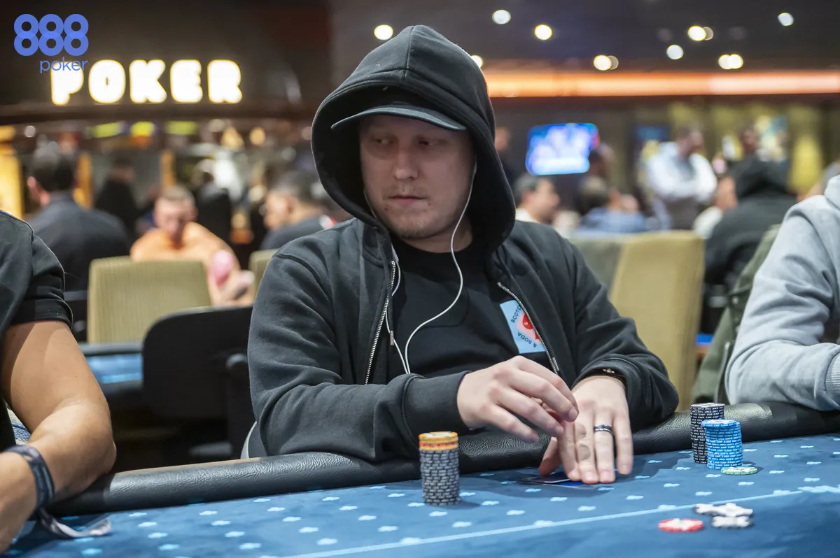 Homem de moleton e capuz joga poker
